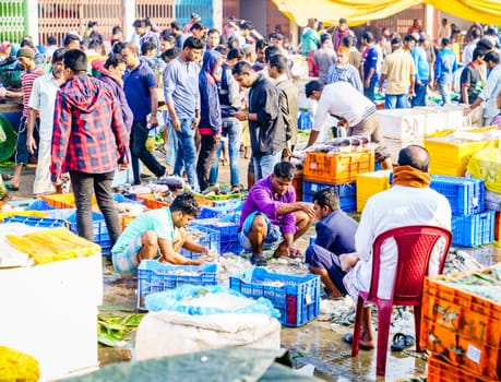 Chittagong, Bangladesh, December 23, 2017: Vendors sorting fish at the crowded market near Karnaphuli River in Chittagong