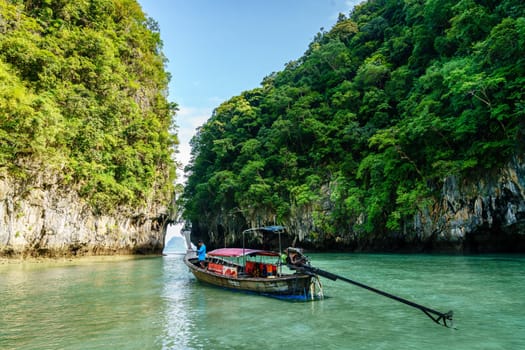 Krabi, Thailand, November 7, 2017: Traditional Thai motor boat by the entrance to a lagoon on Ko Hong island