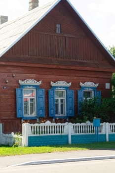 The facade of the old wooden houses in Belarus, with carved architraves