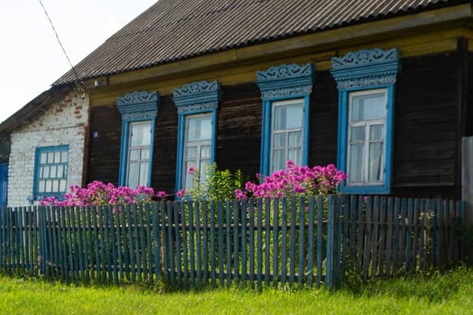 decorative carved window in an old wooden house, rustic decoration of a wooden house, Belarus
