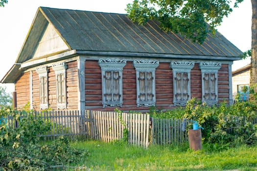 Carved wooden trim of the facade of the old house. Authentic house with carved wooden facade, Belarus