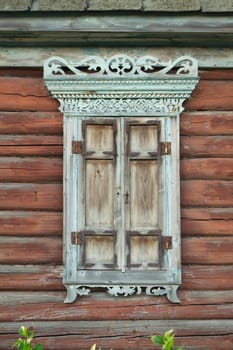 Old house vintage carved windows with wooden lacy shutters close up. Belarus