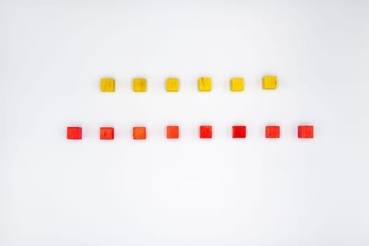 Yellow and red wooden cubes isolated on white background