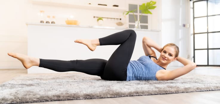Panoramic White caucasian fit sporty woman doing yoga side plank in living room at home for mental health and meditation. Working out, fitness sport and healthy lifestyle concept.