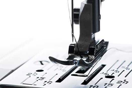 6 - Pure white plain background, dark silhouette of ready to go sewing machine, leading left to right with copy space.
