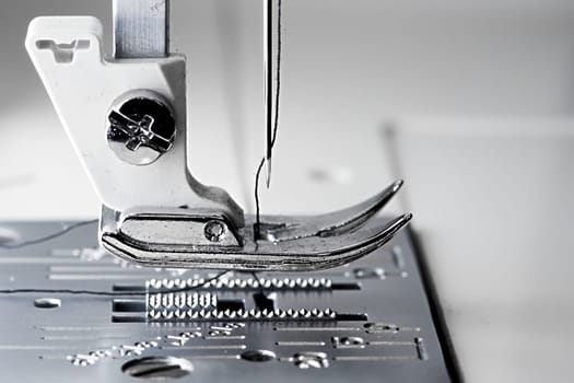 5 - Macro sewing machine side view with flat foot plate ready to stitch.