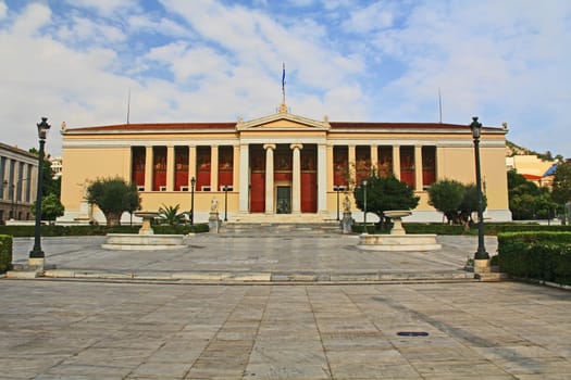 Front street view across the square of the National and Kapodistrian University of Athens, Greece.  Usually referred to as the University of Athens which is a public university.