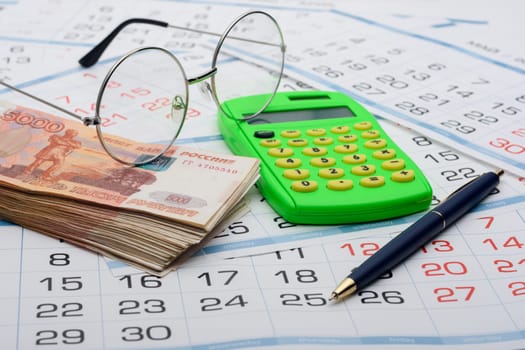 Concept of savings savings for old age, money, pen, calculator and glasses