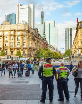 FRANKFURT, GERMANY - AUGUST 31, 2018: Central square crowded with people, skyscrapers of modern architecture, cityscape in sunset light