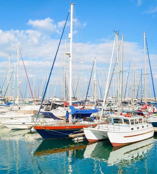 White yachts and motorboats moored in Larnaca marina on sunny day, Cyprus