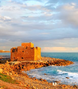 Scenic sunset seascape with clouds and Paphos Harbour Castle view, Cyprus