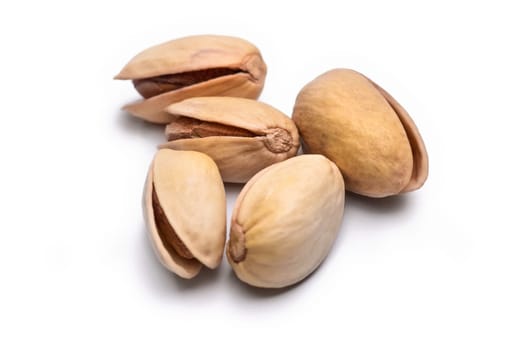 Five roasted pistachio nuts in shell (Pistacia vera) isolated on white background