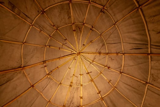Interior view of an Indian sweat lodge. Star-shaped willow sticks covered with fabric tarpaulin