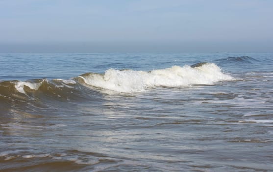 Waves of white foam Crown roll over the sea surface