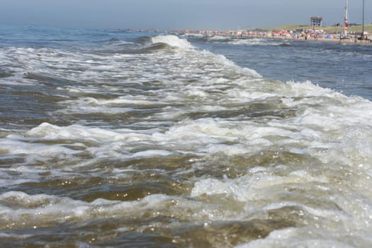 Waves of white foam Crown roll over the sea surface