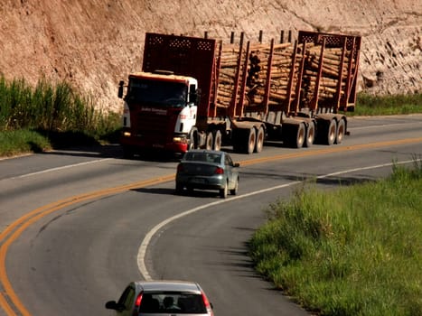 eunapolis, bahia / brazil - april 5, 2011: eucalyptus wood transport cart is seen traveling on highway BR 101 in the city of eunapolis, in southern Bahia.