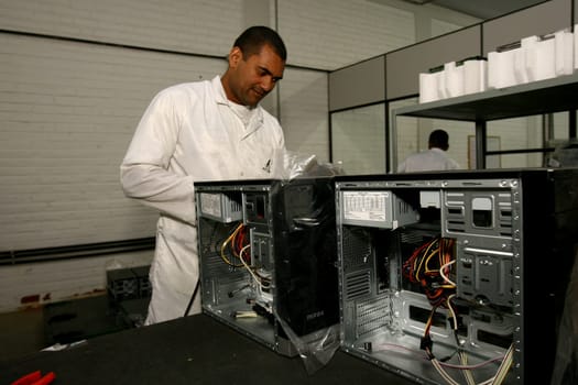 ilheus, bahia / brazil - june 13, 2011: workers are seen on a computer assembly line in a factory at the Informatics Pole in the city of Ilheus, in southern Bahia.