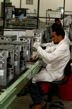 ilheus, bahia / brazil - june 13, 2011: workers are seen on a computer assembly line in a factory at the Informatics Pole in the city of Ilheus, in southern Bahia.