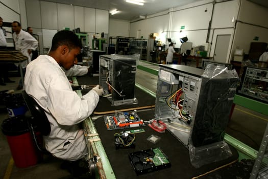 ilheus, bahia / brazil - june 13, 2011: workers are seen on a computer assembly line in a factory at the Informatics Pole in the city of Ilheus, in southern Bahia.