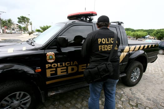 itabuna, bahia / brazil - december 13, 2011: agents of the Federal Police of Brazil are seen during a public embezzlement investigation in the city of Itabuna, in the south of Bahia.