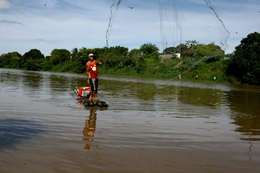 itabuna, bahia / brazil - december 20, 2011: fisherman is seen on a raft in the waters of the Cachoeira river in the city of Itabuna, southern Bahia.