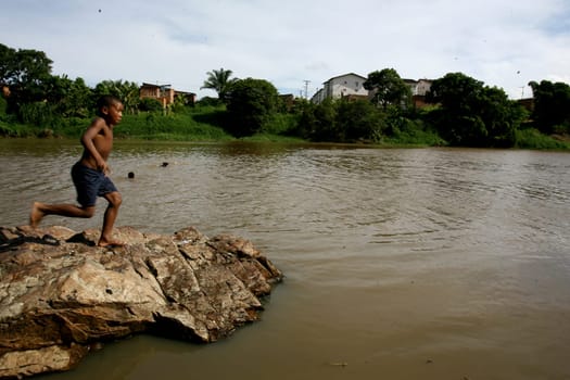 itabuna, bahia / brazil - december 20, 2011: young people are seen along the banks of the Cachoeira river in the city of Itabuna, southern Bahia.