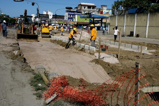 itabuna, bahia / brazil - december 9, 2011: machines and workers are seen during construction of Canal Lava Pes to drain the sewage network in the city of Itabuna, in southern Bahia.