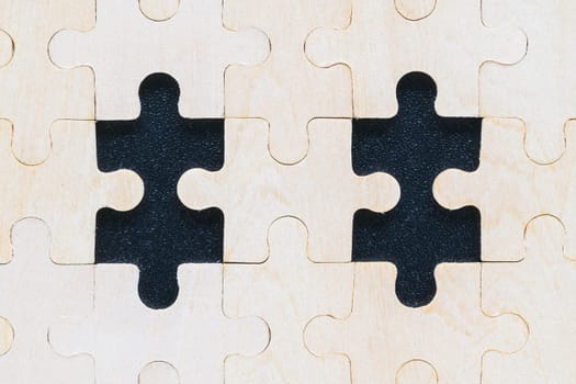 Close up Shot of wooden jigsaw puzzle pieces on black background,Business concept