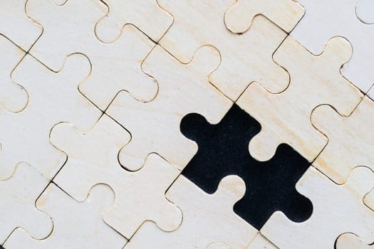 Close up Shot of wooden jigsaw puzzle pieces on black background,Business concept