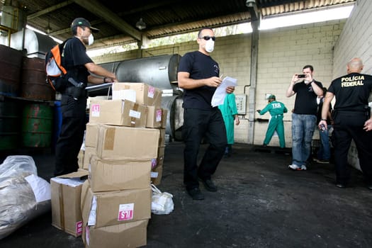 itabuna, bahia / brazil - march 30, 2012: Federal Police agent participates in drug incineration seized in the city of Itabuna, southern Bahia.