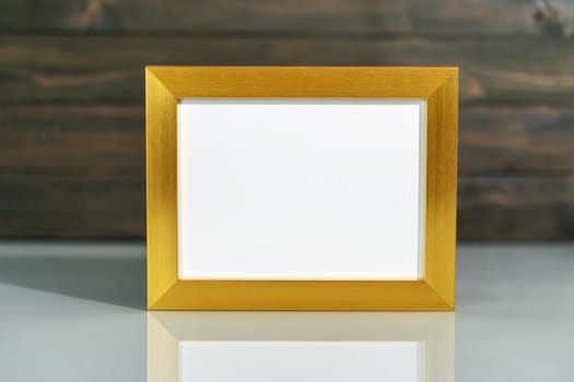 Picture golden frame mock up and Artificial flower vase bouquet over table with wood wall background