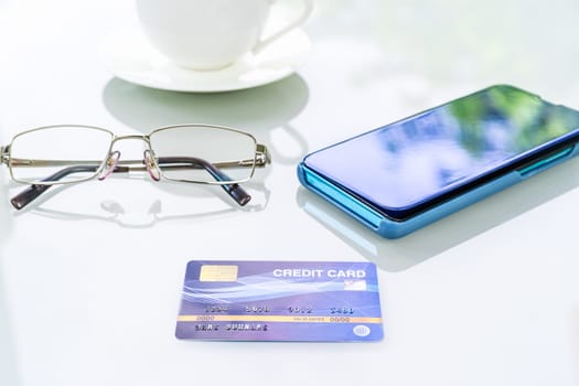 Desk with mobile phone and credit card. Online shopping concept