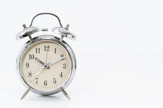Silver alarm clock isolated on white background