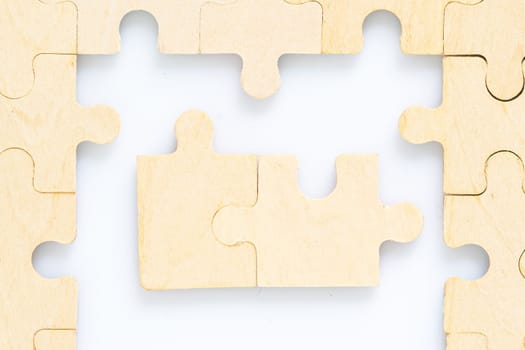 Shot of wooden jigsaw puzzle pieces on white background,Business concept