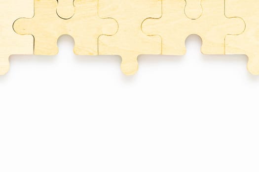Shot of wooden jigsaw puzzle pieces on white background,Business concept