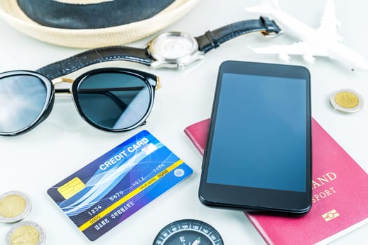 Traveling concept,smart phone, passport, credit card,sun glasses on white background