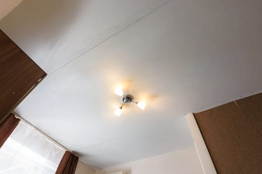 View of the old ceiling in need of repair in the apartment