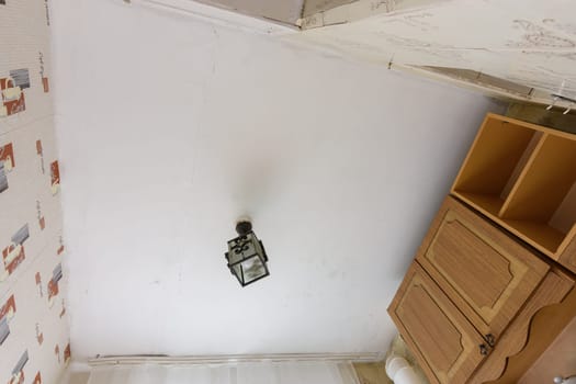 Anapa, Russia - June 25, 2020: Old plastered ceiling in the kitchen in need of renovation