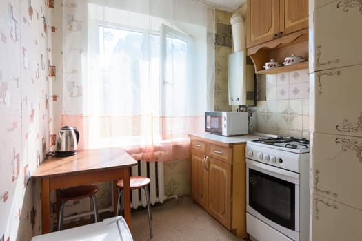 Anapa, Russia - June 25, 2020: Kitchen in a small apartment with an outdated interior