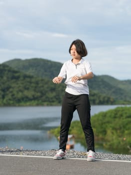 Fitness and lifestyle concept - Young asian woman short hair doing exercising outdoor