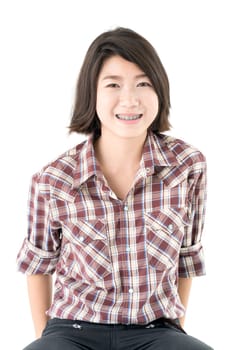 Young pretty woman in plaid shirt posing in studio with isolated on white background