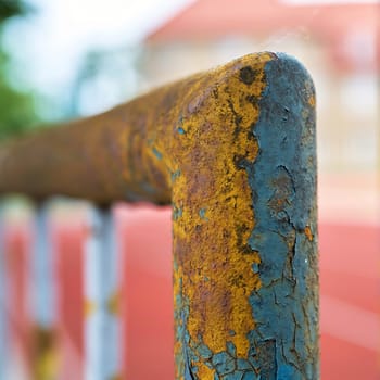 paint flaking off an old dilapidated rusty fence