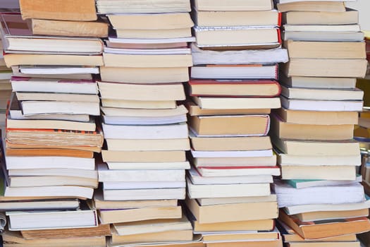 Big pile of books at table in library