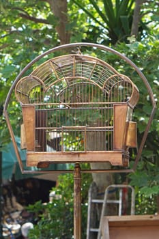 Antique style metal birdcage at pole