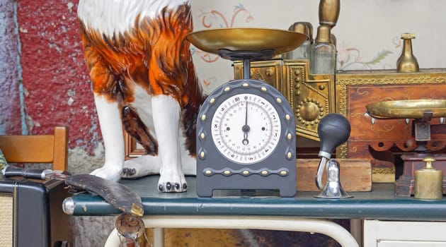 Vintage style weighing scale at shelf in flea market
