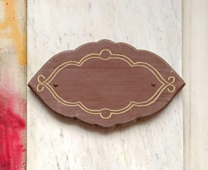 Wooden sign in interesting shape at wall
