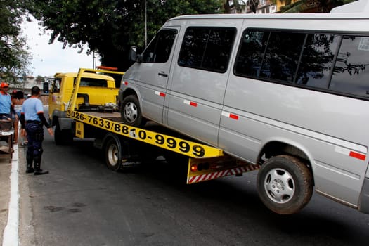 salvador, bahia / brazil - april 7, 2013: winch is seen picking up van parked in a prohibited place in the city of Salvador.