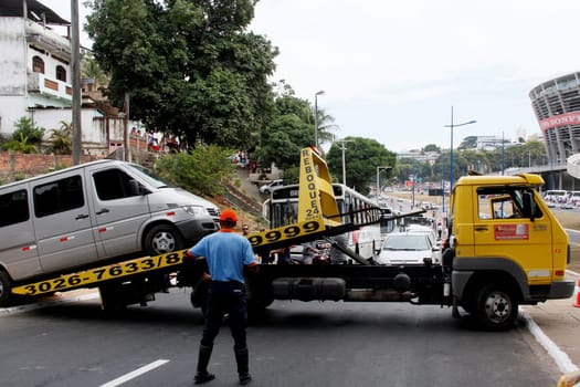 salvador, bahia / brazil - april 7, 2013: winch is seen picking up van parked in a prohibited place in the city of Salvador.