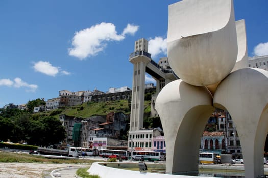 salvador, bahia / brazil - march 21, 2013: sculpture by Mario Cravo in the Comercio neighborhood and in the background the Lacerda Elevator in the city of Salvador.