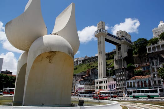 salvador, bahia / brazil - march 21, 2013: sculpture by Mario Cravo in the Comercio neighborhood and in the background the Lacerda Elevator in the city of Salvador.